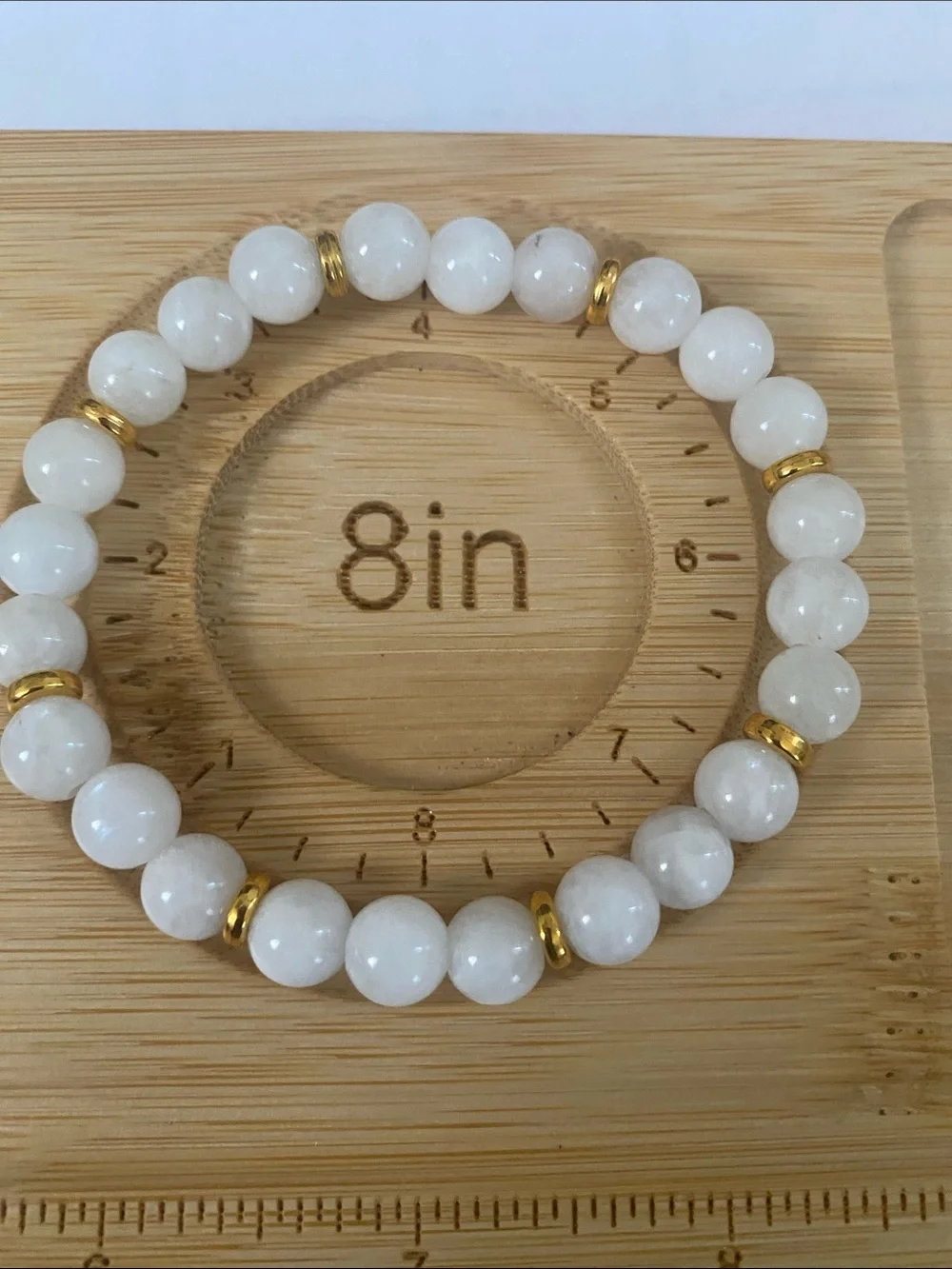 White Beaded Bracelet with Pink Focal Stone and Gold Accents